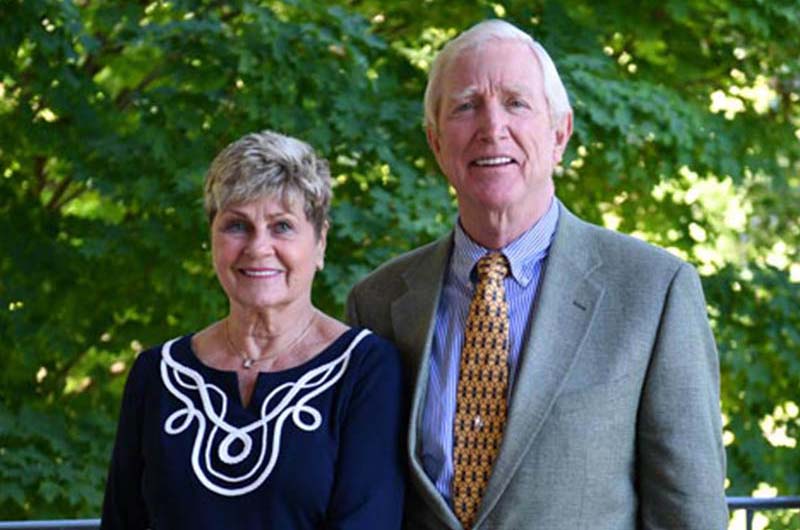 Barry-Humphries-and-his-wife-smile-and-stand-outside-on-the-patio-at-10-Wilmington-Place