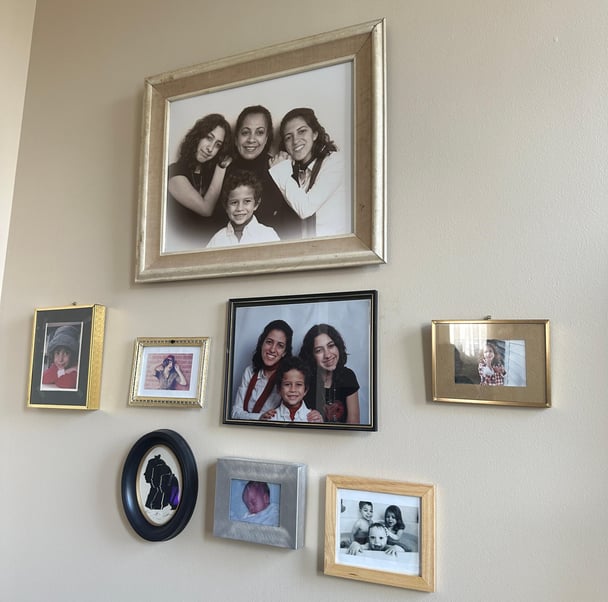 Family photos hung on the wall of an apartment